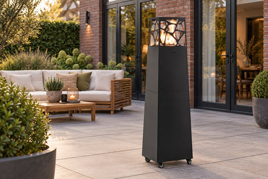 Planika Pyramid outdoor gas patio heater in black on a backyard patio next to an outdoor sofa
