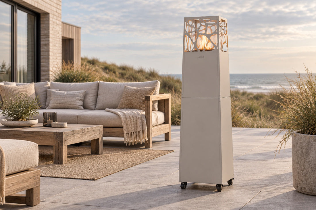 Planika glass flame tower patio heater on a patio at night