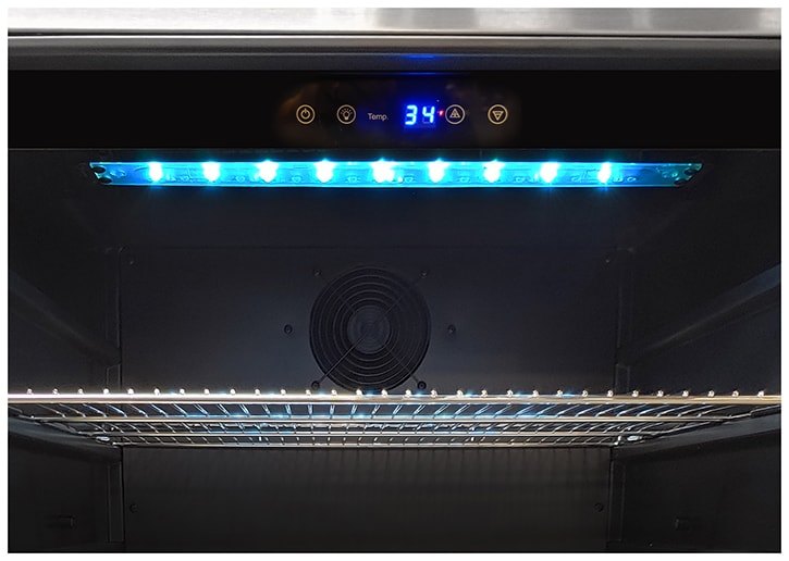 Artisan 24" outdoor refrigerator interior with LED lighting and stainless shelves
