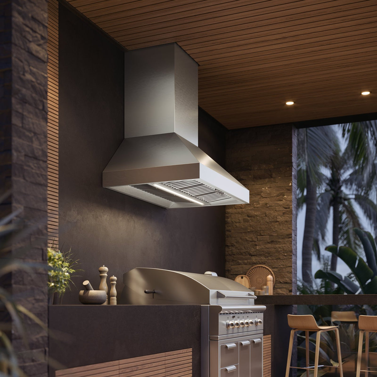 Falmec Pyramid Outdoor stainless range hood installed in a covered outdoor kitchen