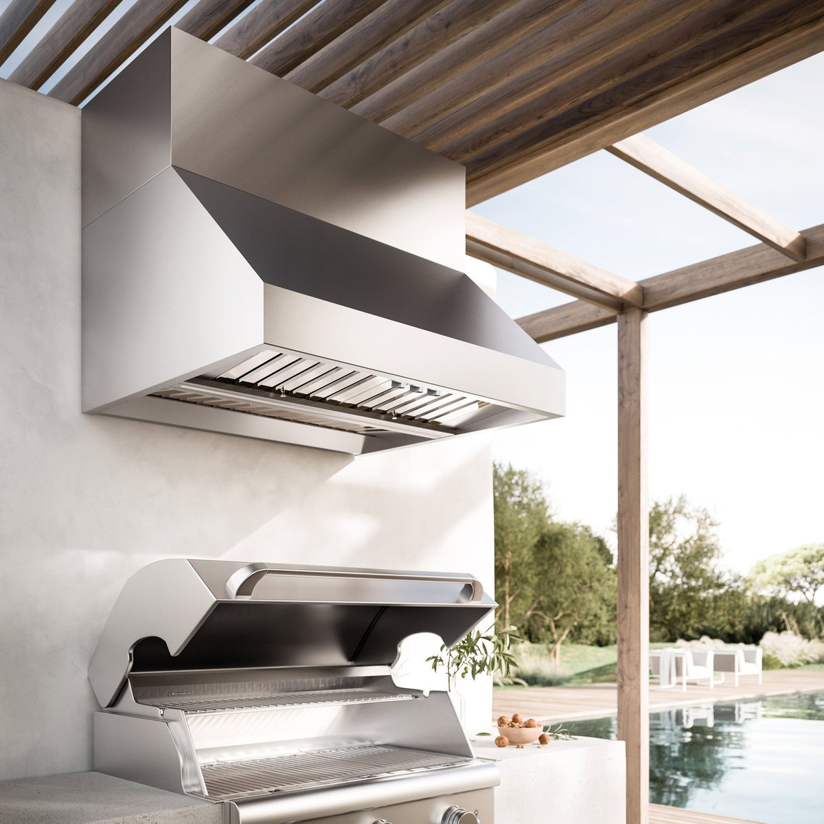 Falmec Zeus Outdoor hood above a built-in grill, shown with optional chimney kit (sold separately)