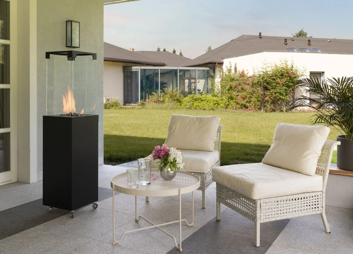 Outdoor patio setting with chairs, table, and fire pit in a residential backyard.