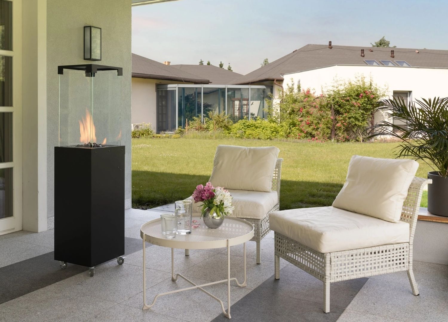 Outdoor patio setting with chairs, table, and fire pit in a residential backyard.