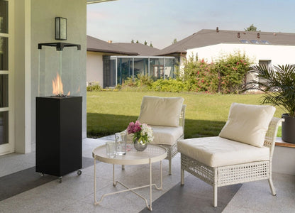 Outdoor patio setting with chairs, table, and fire pit in a residential backyard.