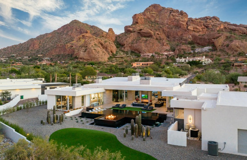 Aerial view of a desert estate with a gas fire pit on the terrace